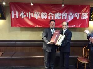 遠從秋田縣到場參加的副部長又井公久（左）特別送上當地名產給沈斯淳